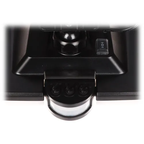 Zbliżenie na czarny panel sterowania z pokrętłem i przełącznikiem, umieszczony na urządzeniu. Na dole widoczny jest czujnik ruchu z trzema pokrętłami regulacyjnymi.