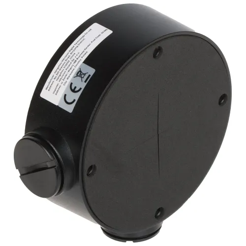 Czarna, okrągła obudowa kamery z widocznymi śrubami montażowymi i oznaczeniami CE. Na boku znajduje się złącze kablowe z zaślepką.