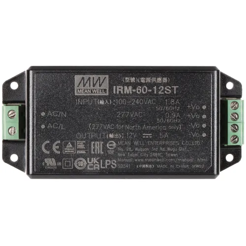Zdjęcie przedstawia zasilacz impulsowy Mean Well IRM-60-12ST z widocznymi oznaczeniami technicznymi i certyfikatami na obudowie. Urządzenie ma czarną, prostokątną obudowę z zielonymi złączami po bokach.